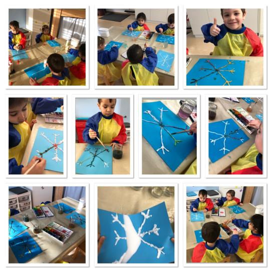 Kinder am Schneeflocken basteln